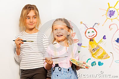 Two smiling painters drawing funny picture Stock Photo
