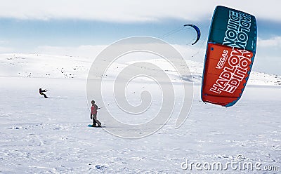 Two snowkiter rides on a snow-covered field in the Arctic. Murmansk region Editorial Stock Photo