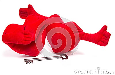 Two soft toy hearts with handles were going to embrace a key Stock Photo