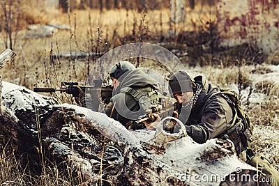 Two soldiers in an ambush aim at the enemy Stock Photo