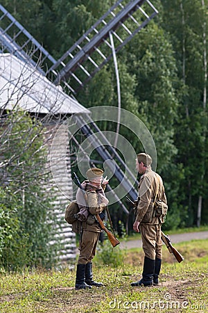 Two Soviet soldiers of the second world war near the windmill Editorial Stock Photo