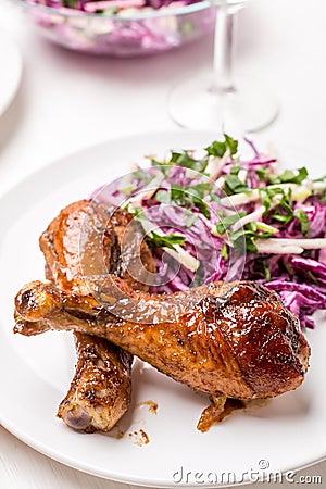 Two Spicy Glazed Roasted Chicken Drums with Salad Stock Photo