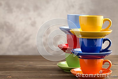 Two stacks multicolored cups on table from right side Stock Photo