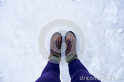 Two standing feet on the snowy icy ground Stock Photo