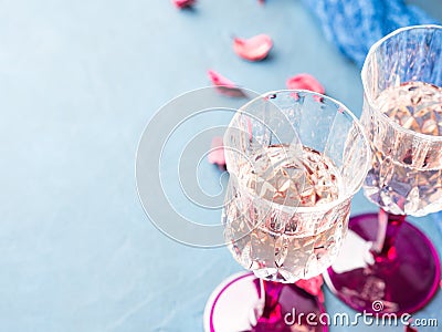 Two stemmed glasses with champagne on blue Stock Photo