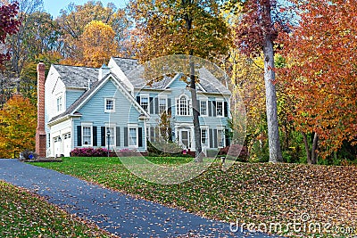 two-story house among autumn trees. Asphalt driveway to garage Editorial Stock Photo