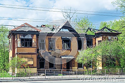 The two-story house after a fire. The destroyed roof. Stock Photo