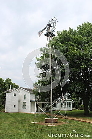 Two Story Outhouse, Windmill, and 1850`s House Stock Photo
