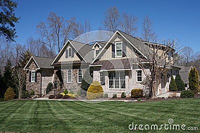 Suburban home with a stone and brick exterior and nice landscaping in a neighborhood in North Carolina Stock Photo