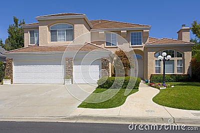 Two Story Stucco Home With A Street Light Stock Photo