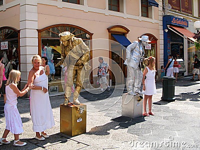 Two street actors in the image of living statues on the street Massena in the city Nice, France. Editorial Stock Photo