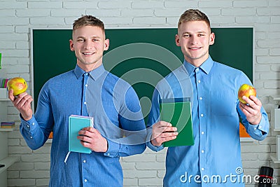 Two student holding books and smiling at camera. Learning and education concept. Group of high school students in Stock Photo