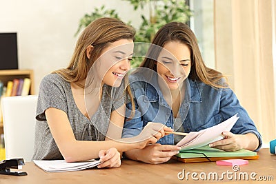 Two students doing homework at home Stock Photo