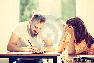 Two students talking in classroom Stock Photo