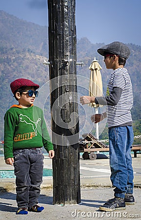 Two stylish kids wearing caps having fun together Editorial Stock Photo