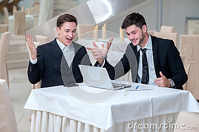 Two successful businessmen are showing positive emotions Stock Photo