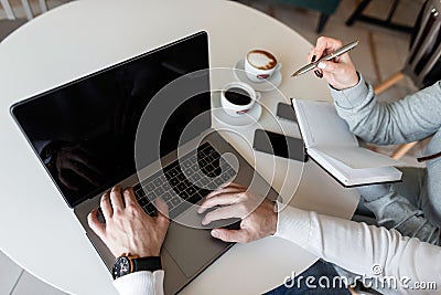 Two successful professionals a man and a woman are looking for ideas online for their business project. Stock Photo