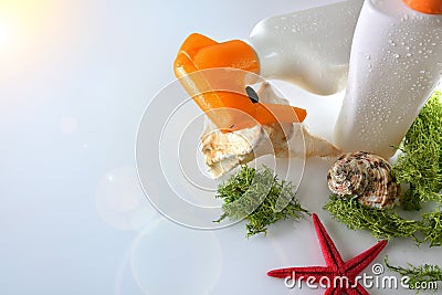 Two sunscreen spray on shells on glass table elevated view Stock Photo