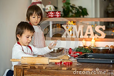 Two sweet children, boy brothers, preparing gingerbread cookies Stock Photo