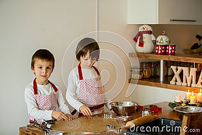 Two sweet children, boy brothers, preparing gingerbread cookies Stock Photo