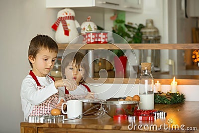 Two sweet children, boy brothers, preparing gingerbread cookies Stock Photo