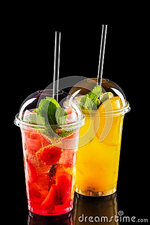 Two take away glasses with strawberry and orange lemonade Stock Photo