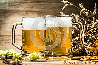 Two tankard beer closeup on wooden table Stock Photo