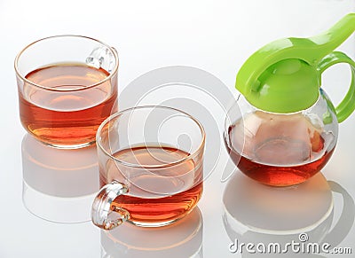 Two Tea Cup and Kettle in white reflective background Stock Photo