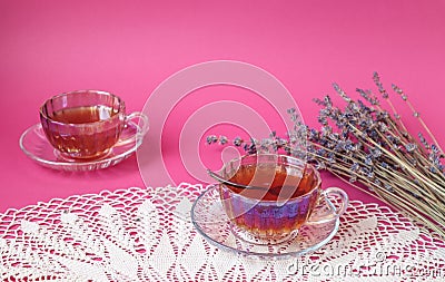 Two teacups with a bouquet of lavender on a pastel background, space for text Stock Photo