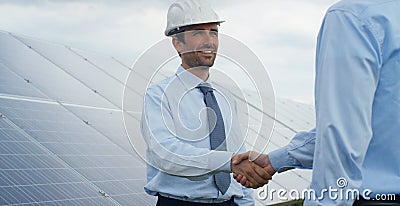 Two technical expert partners in solar photovoltaic panels, remote control performs routine operations to monitor the system using Stock Photo