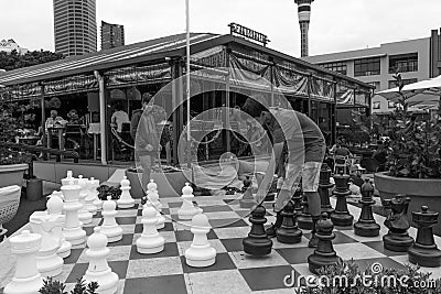 Two teenage boys playing outdoor chess Editorial Stock Photo