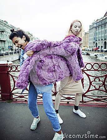 Two teenage girls infront of university building smiling, having Stock Photo