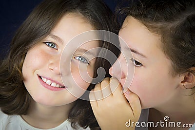 Two teenage girls telling secret Stock Photo