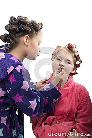 Two teenager girls playing Housewives, do yourself hairstyles and makeup having fun Stock Photo