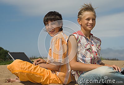 Two teens with laptops Stock Photo