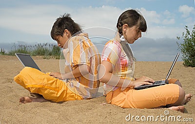 Two teens with laptops Stock Photo