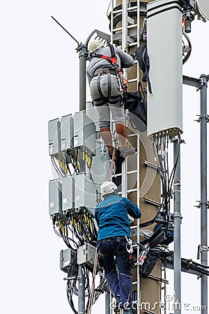 Telekom technicians perform work on a transmission tower Editorial Stock Photo