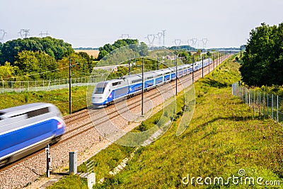 Two TGV high speed trains passing each other in the french countryside Editorial Stock Photo