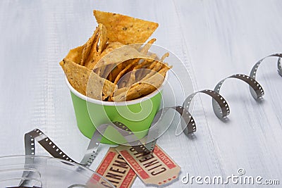 Two tickets to the cinema, under a bucket of nachos and unwrapped tape for film Stock Photo