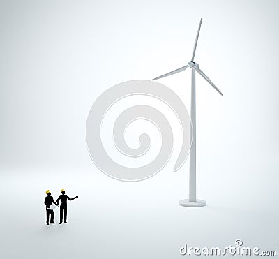 Two tiny engineers building a wind farm Stock Photo