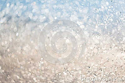 Two-tone abstract background: blurred splashes of water drops in the setting sun. Stock Photo