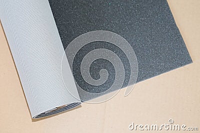 Two tone grey and dark gray fabric textile roll on brown cardboard background Stock Photo