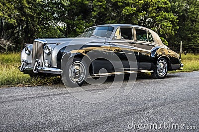Two-toned, luxury antique classic car on a rural country road Stock Photo