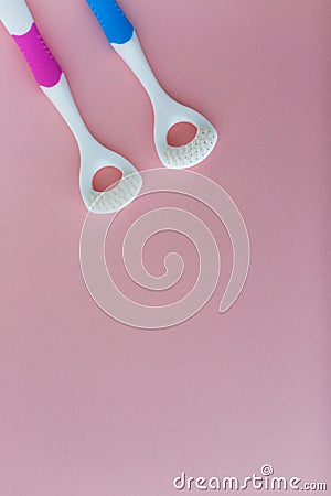 Tongue brushes on the pink background Stock Photo