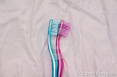Two toothbrushes arranged like couple on bed spooning Stock Photo
