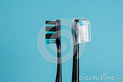 Two toothbrushes on a blue background Stock Photo