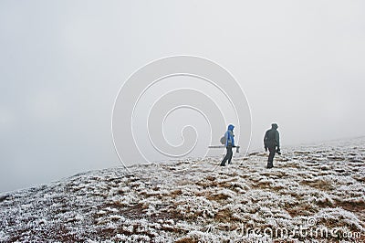 Two tourist photographer with tripod on hand walking on frozen h Stock Photo