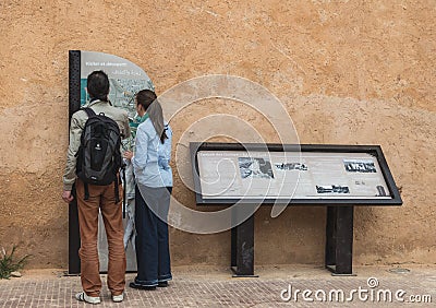Two tourist read guiding map of Kasbah of the Udayas Editorial Stock Photo