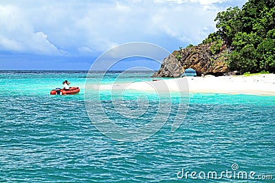 Two tourist sitting on red boat travel to beautiful island with white sand, long beach and stone canal at Krabi, Thailand Stock Photo