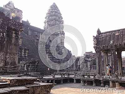 Two tourists inside the Angkor Wat temple in the Khmer temple complex of Angkor Stock Photo
